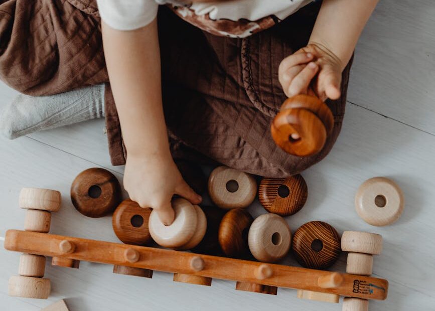 overhead shot of a boy playing with wooden toys